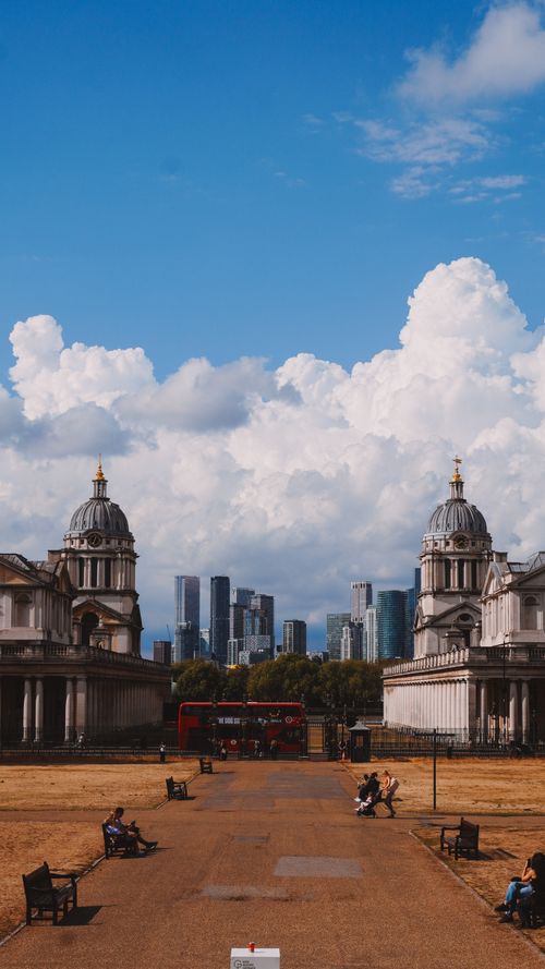 Free View of London's skyline framed by historic architecture and a vibrant sky. Stock Photo