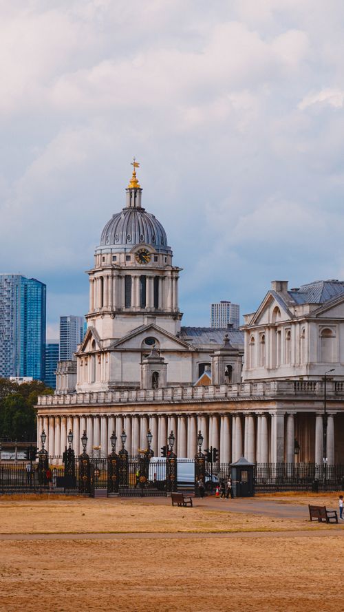 Free Beautiful historic architecture in Greenwich, London with a city skyline backdrop. Stock Photo