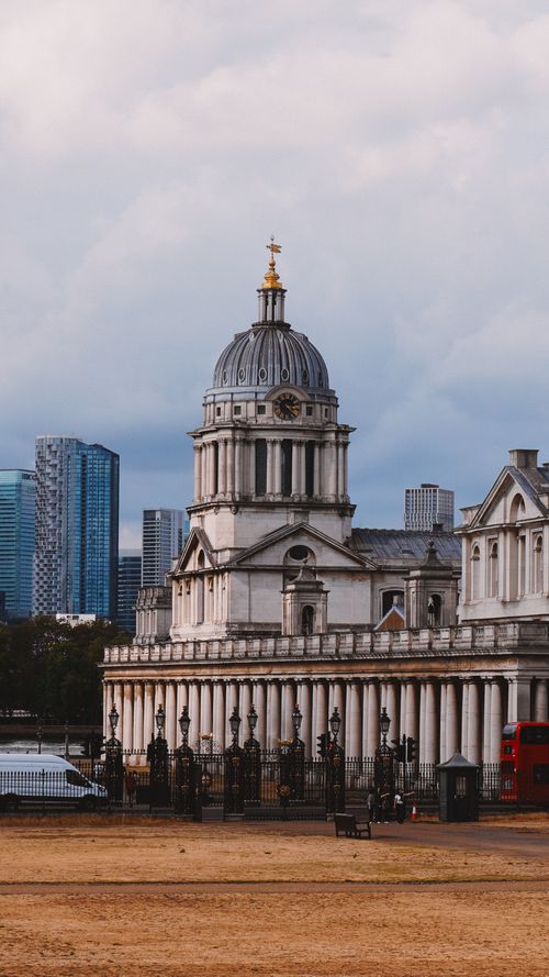 Free The majestic Old Royal Naval College in Greenwich, London, captured with modern skyscrapers in the background. Stock Photo
