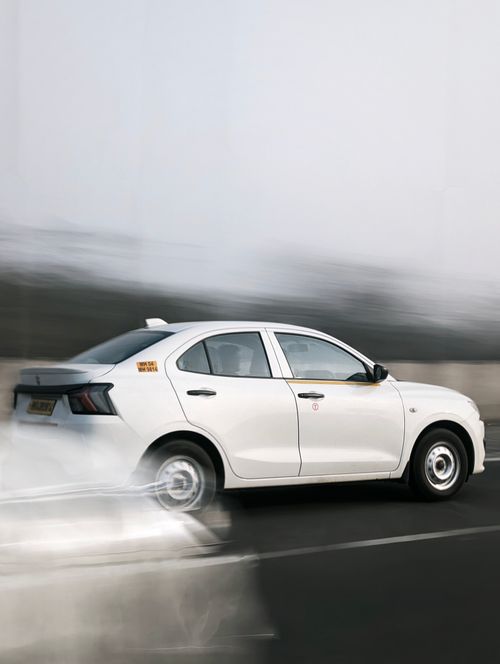 Free Dynamic shot of a white sedan speeding on a highway with motion blur effect, capturing speed and movement. Stock Photo
