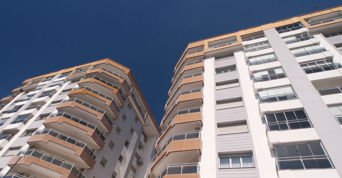 High-rise residential buildings in Izmir showcasing modern architecture under a clear blue sky.