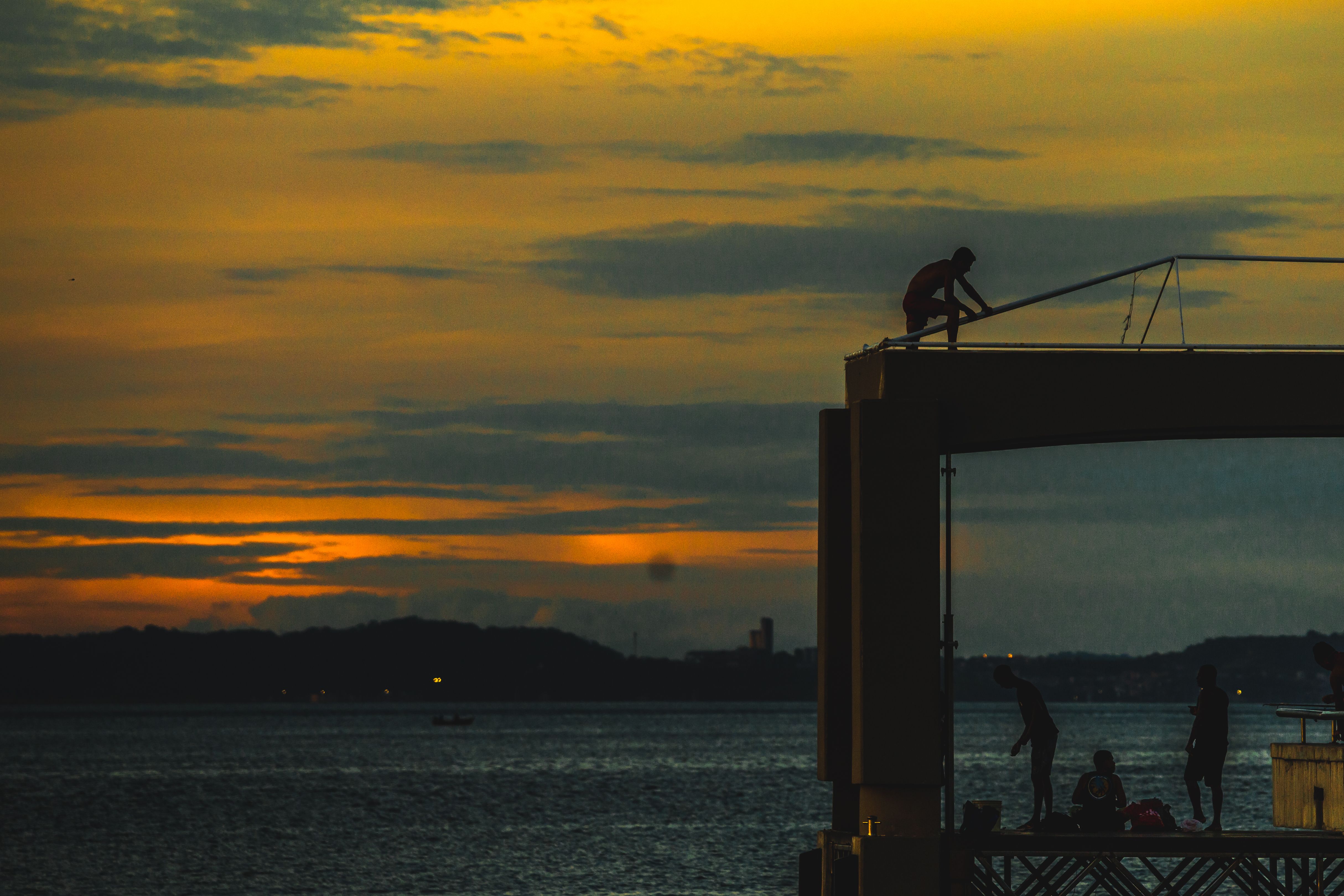 A Silhouette of a Body of Water During Golden Hour · Free Stock Photo