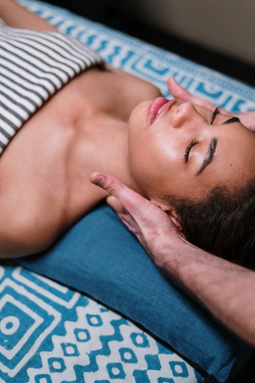 Free Woman Lying on Blue Textile Stock Photo