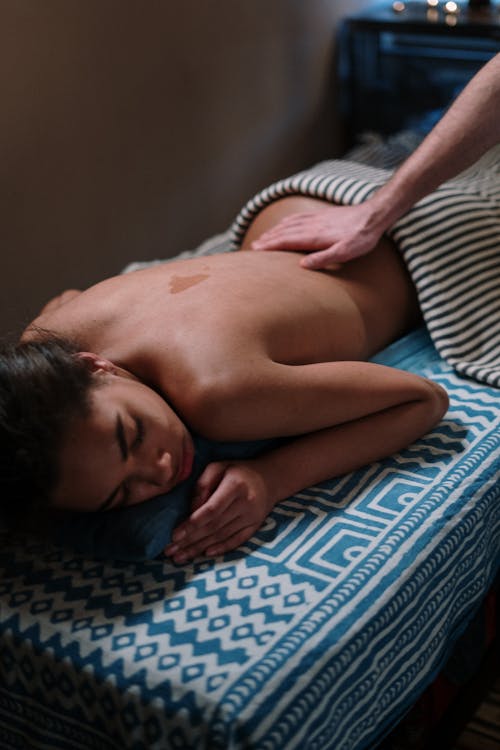 Topless Woman Having a Body Massage
