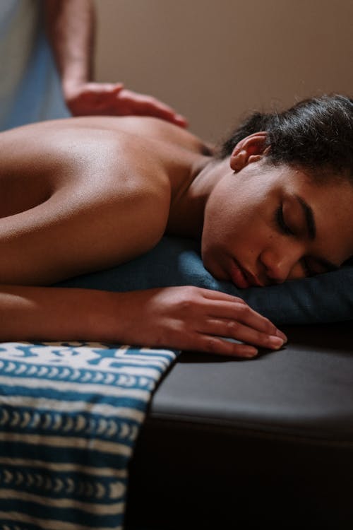 Topless Man Lying on Bed