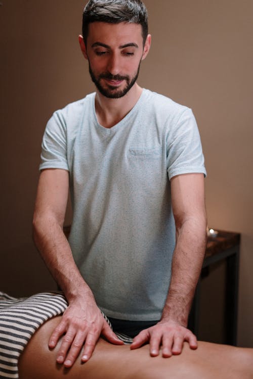Free Man in White Crew Neck T-shirt Giving a Massage Stock Photo