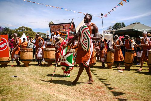 Free Vibrant scene of an African drumming festival with performers in colorful traditional attire. Stock Photo
