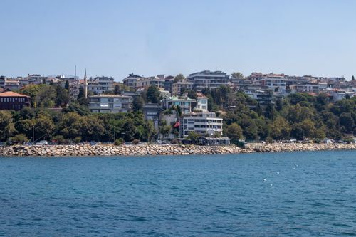 Free Beautiful coastal view of Istanbul's cityscape with clear blue water and urban buildings. Stock Photo