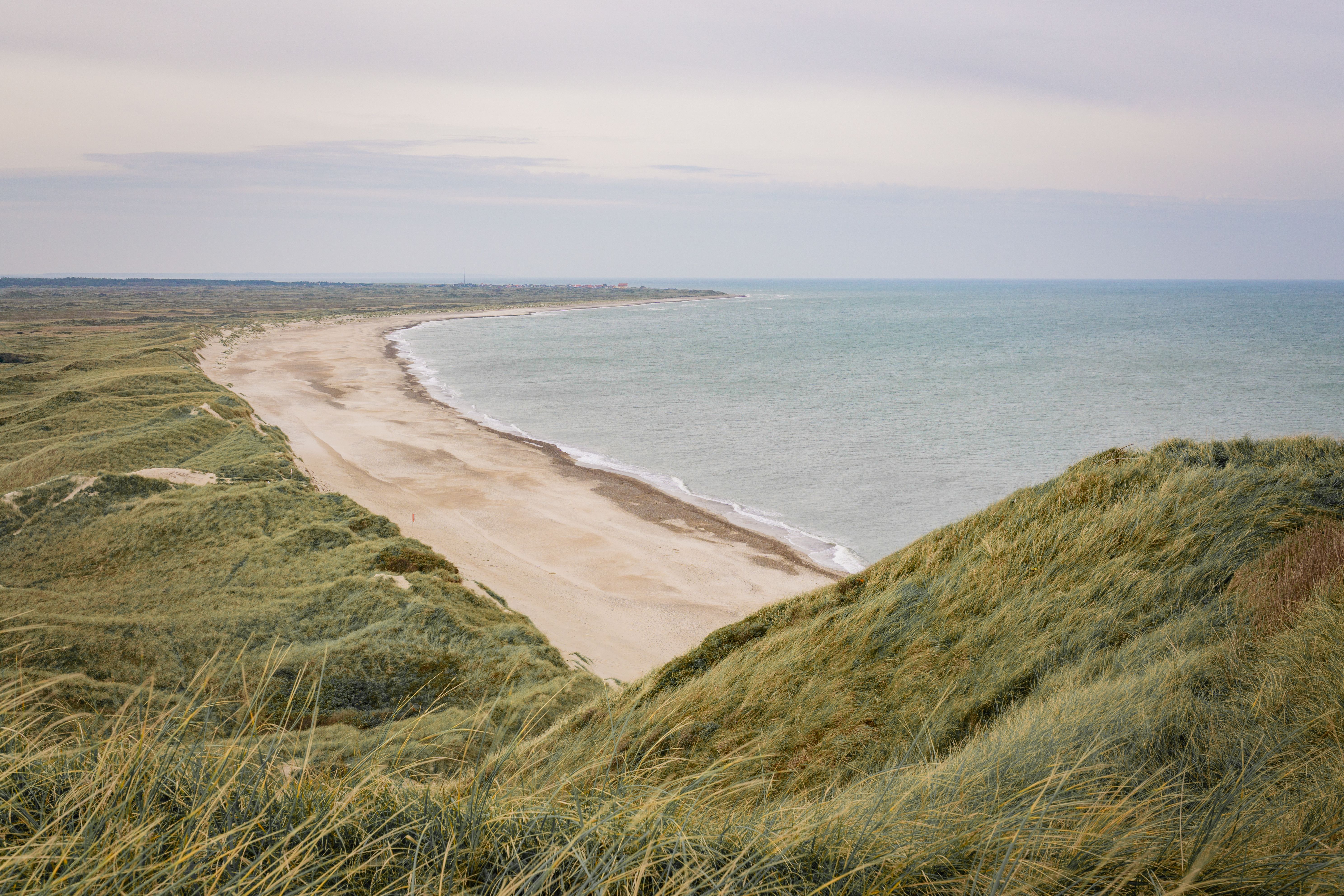 Breathtaking coastline view at Fjerritslev, Denmark, showcasing sandy beaches and lush dunes.