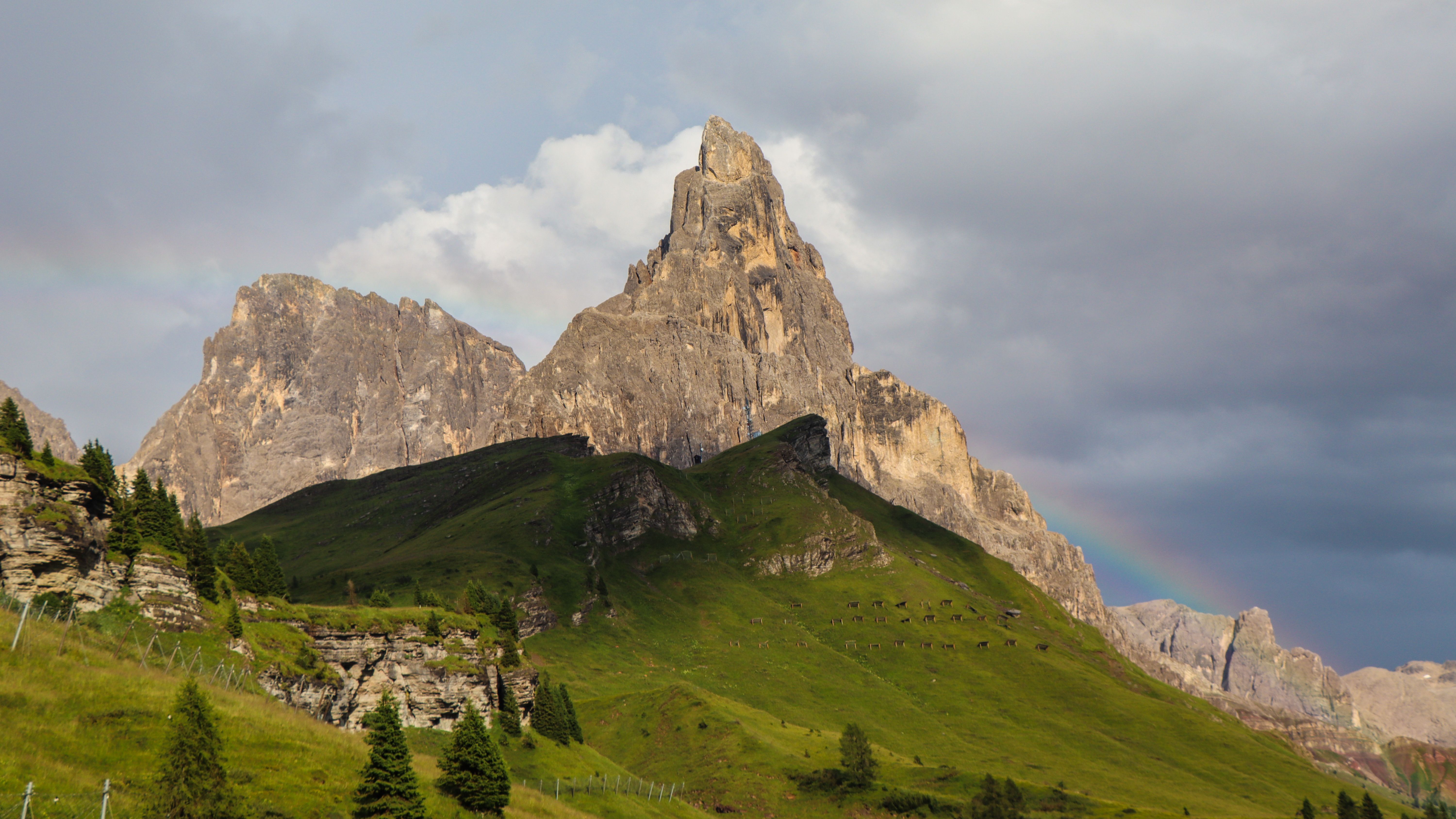 Stunning view of Dolomites' peaks with a rainbow in Trentino-Alto Adige, Italy.