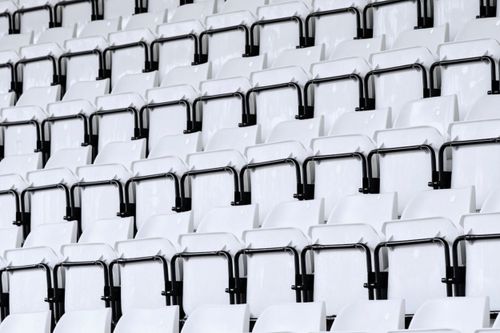 Free Rows of empty white stadium seats featuring modern design with repeating patterns. Stock Photo