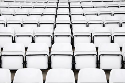 Free Rows of empty white stadium seats, showcasing minimalist architecture and repeating patterns. Stock Photo