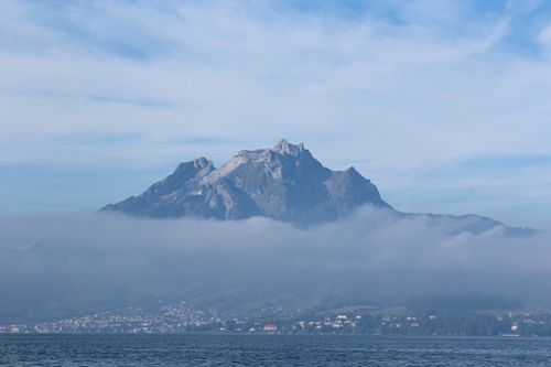 Free A breathtaking view of Mount Pilatus rising above the clouds over Lake Lucerne in Switzerland. Stock Photo