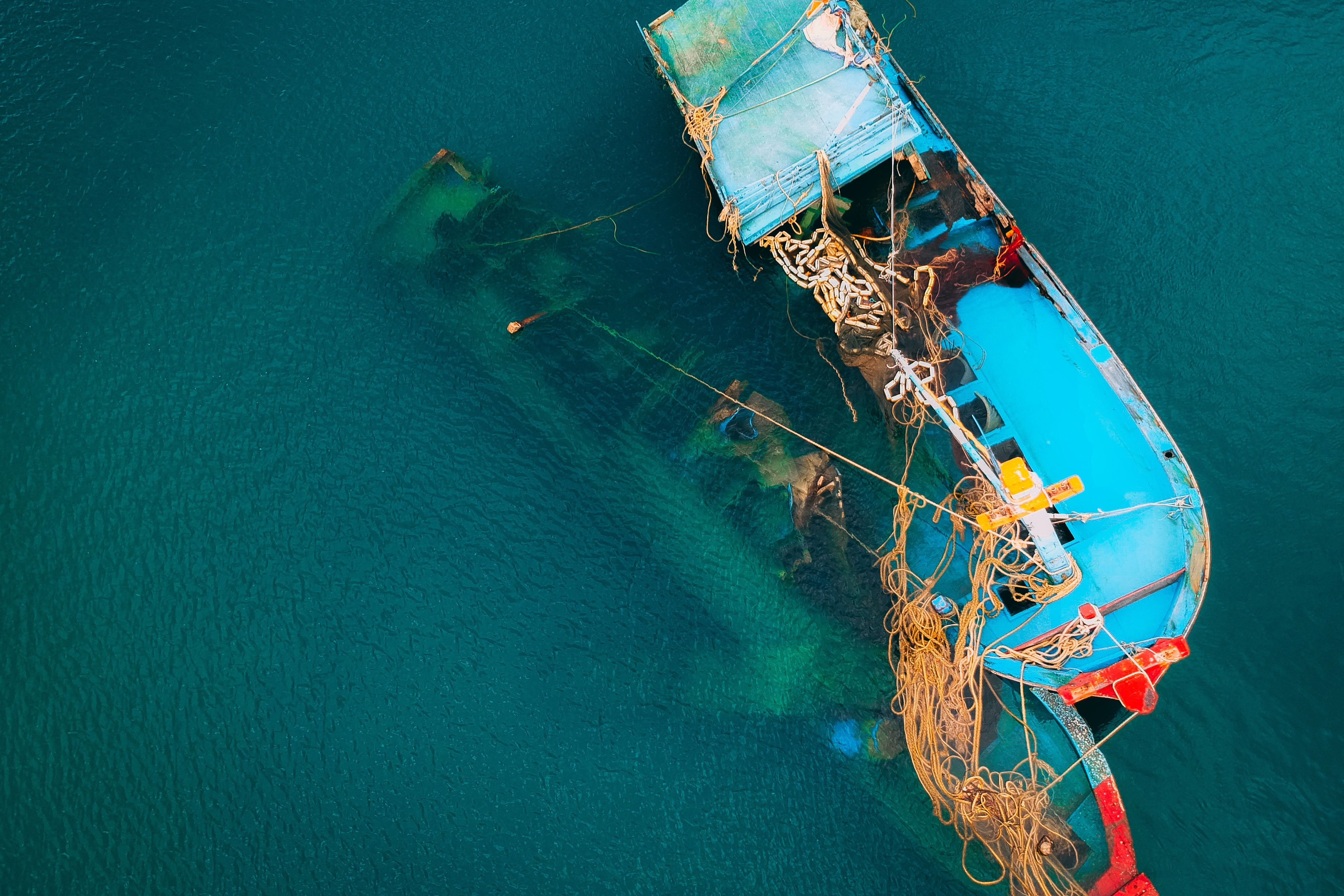 Aerial view of a fishing boat in clear ocean water