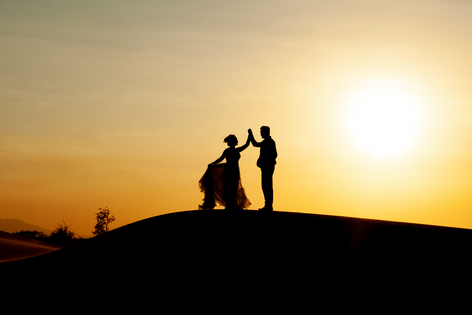 couple standing in the high desert at sunset