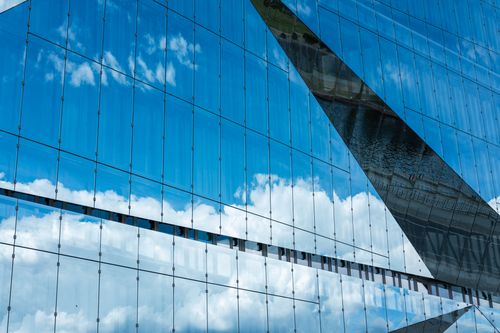 Free Distinctive architecture with glass facade reflecting clouds in Berlin, Germany. Stock Photo