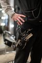 Person in Black Long Sleeve Shirt Holding Gold and Silver Beaded Bracelet