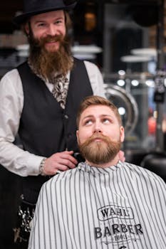 A bearded man receiving a haircut from a barber in a stylish barbershop setting.