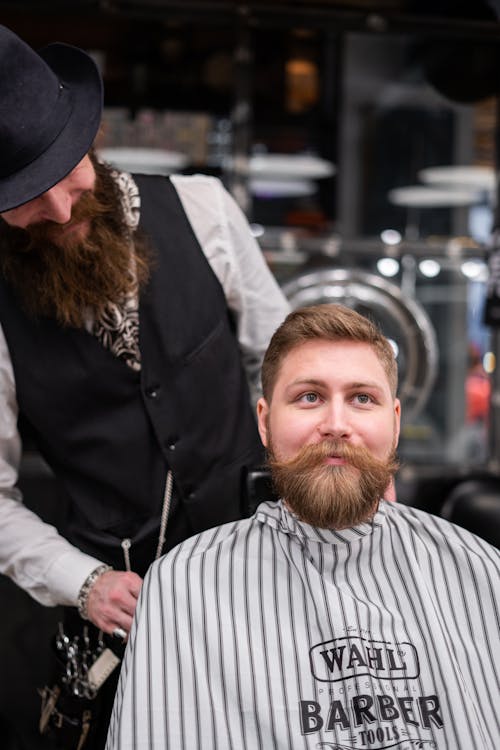 Man in Black Suit Jacket Doing a Client's Hair