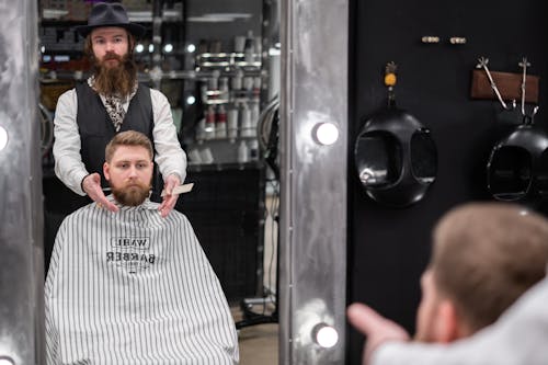 Free Man in Black Hat Giving a Haircut Stock Photo