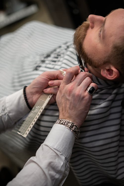 Man in White and Blue Striped Dress Shirt Wearing Silver Link Watch