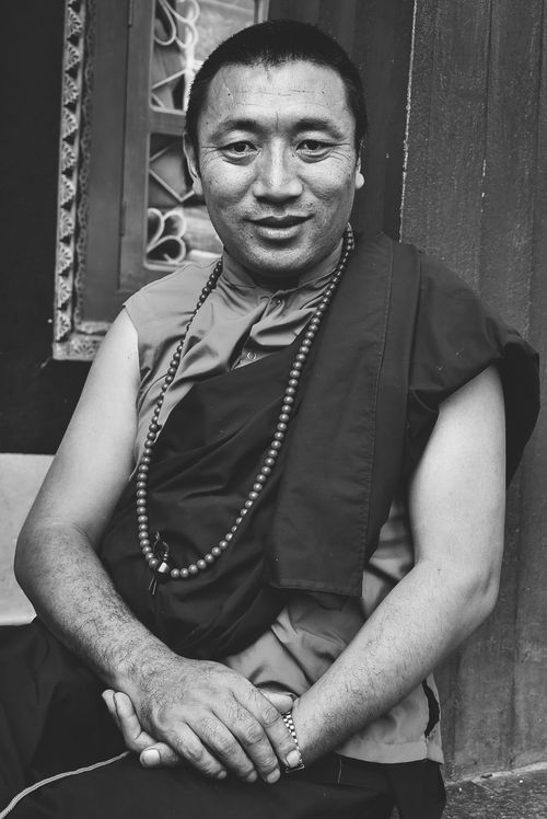 Free Captivating monochrome portrait of a smiling Buddhist leader in Kathmandu, Nepal. Stock Photo