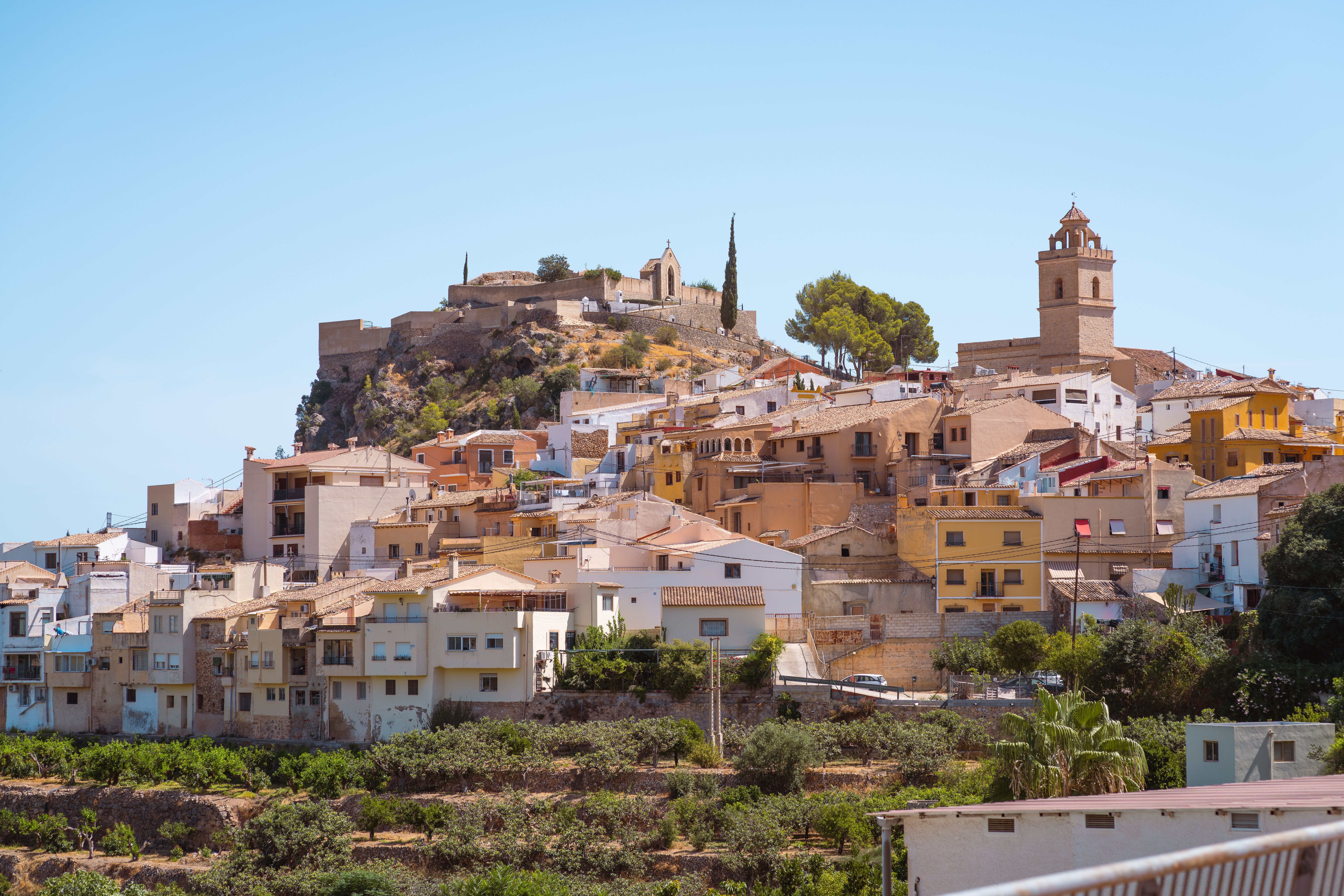 Explore the charming architecture and historic landmarks of Xàtiva's old town on a sunny day.
