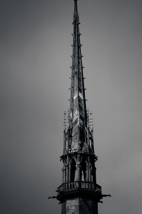 Free Dramatic gothic spire rising against a dark, moody sky, showcasing intricate architectural details. Stock Photo