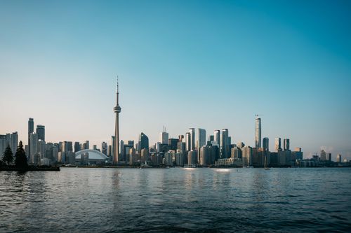 Free A stunning view of the Toronto skyline with the iconic CN Tower during sunset. Stock Photo