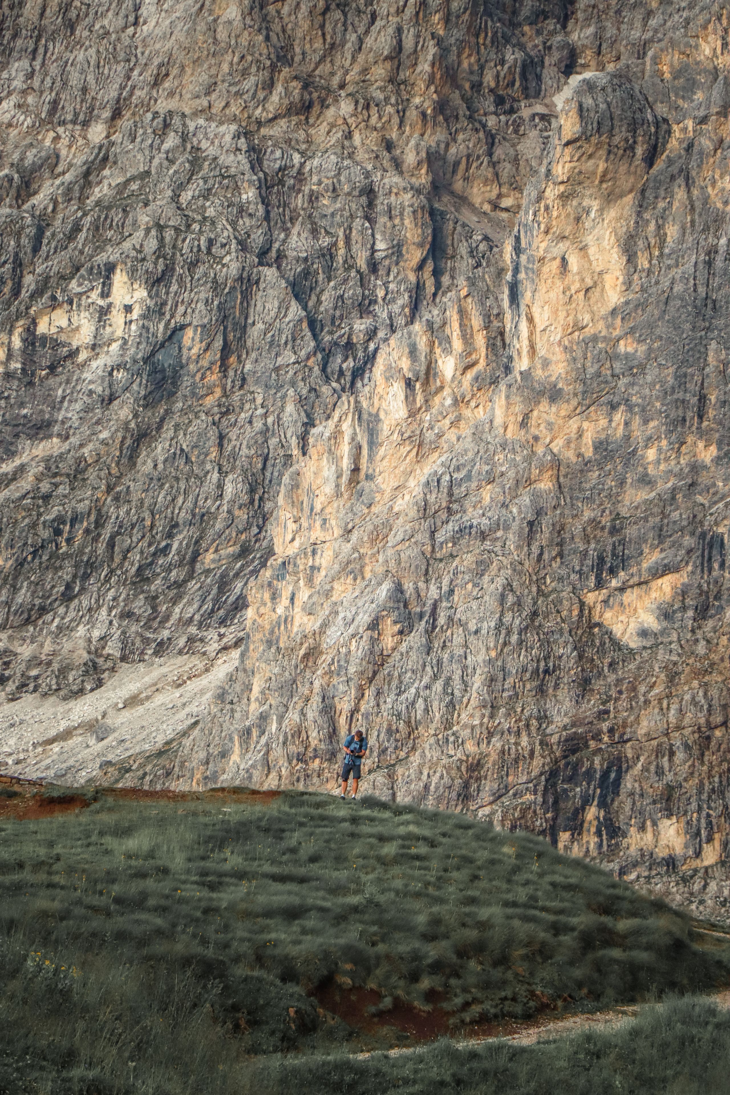 A lone hiker stands beneath 