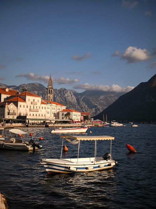 Free Picturesque coastal town of Perast with boats on a sunny day. Stock Photo