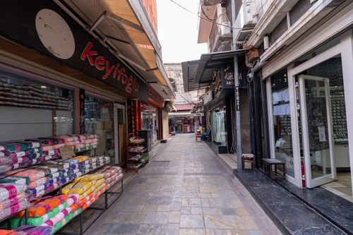 Free Empty street in İzmir market with colorful textiles and shops lining the alley. Stock Photo