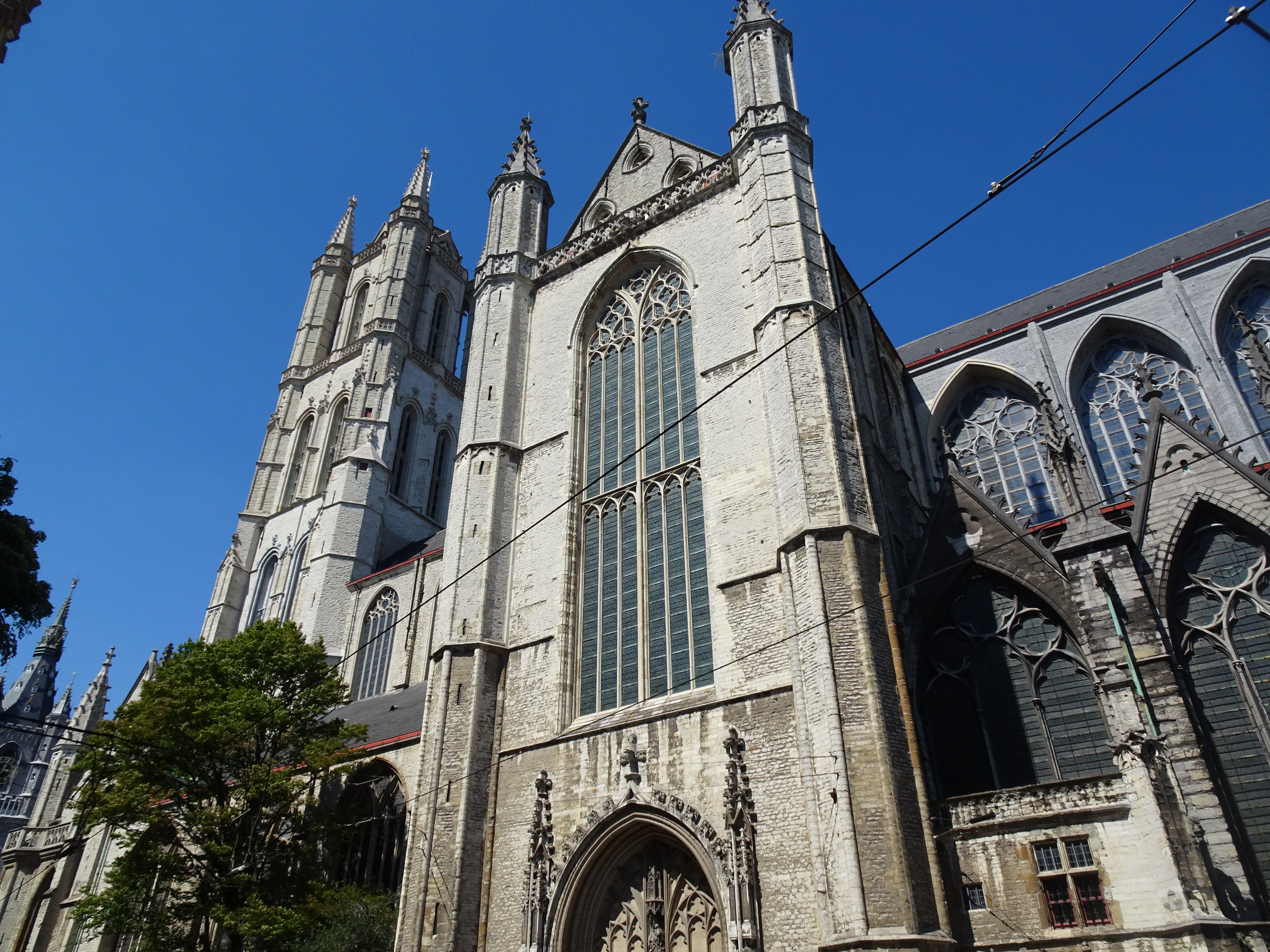 Stunning medieval architecture of Saint Bavo's Cathedral in Ghent, Belgium on a sunny day.