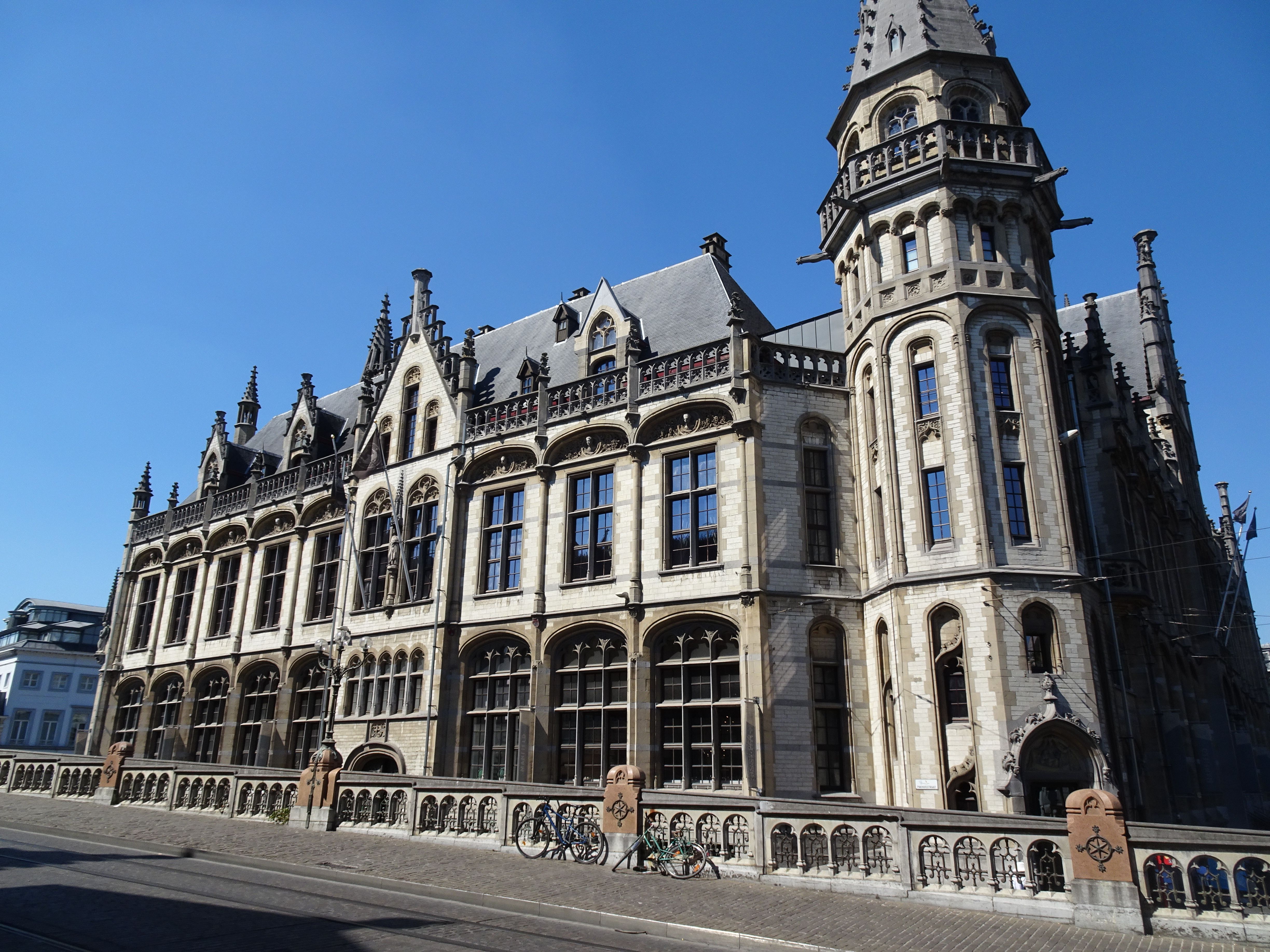 Stunning Gothic building in Ghent, Belgium, showcasing medieval architecture under a bright blue sky.