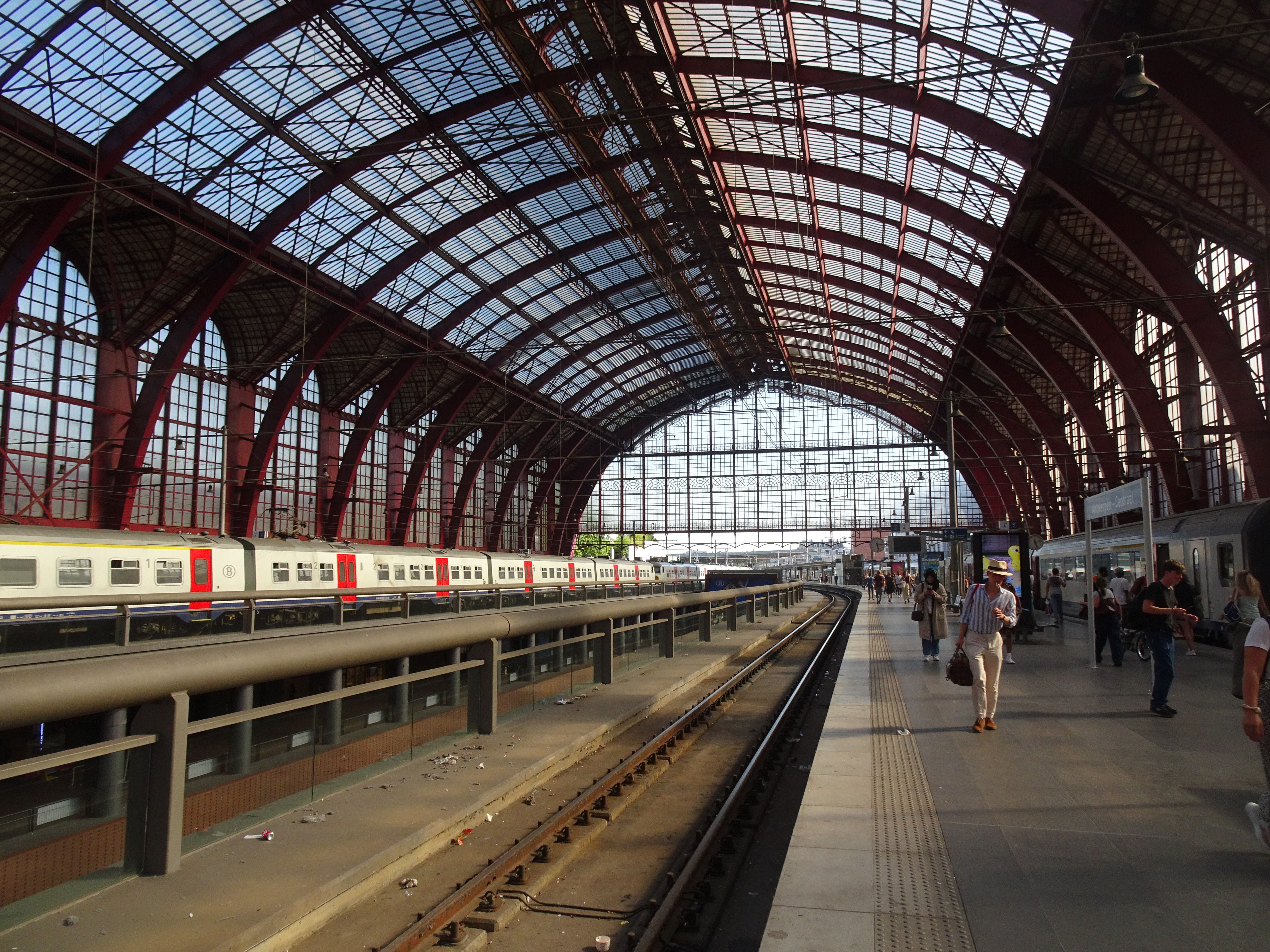 Capture of Antwerp Central Station with travelers and trains, showcasing its grand architecture.