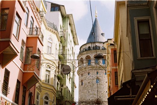 View of Galata Tower surrounded by colorful buildings in Istanbul.