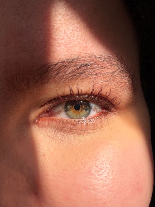 Free A human eye captured in natural sunlight highlighting the intricate details and colors. Stock Photo