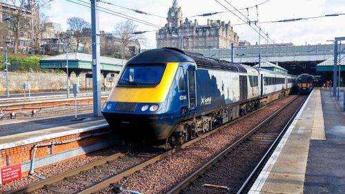 Free Scotrail train arriving at Edinburgh Waverley Station, Scotland on a clear day. Stock Photo
