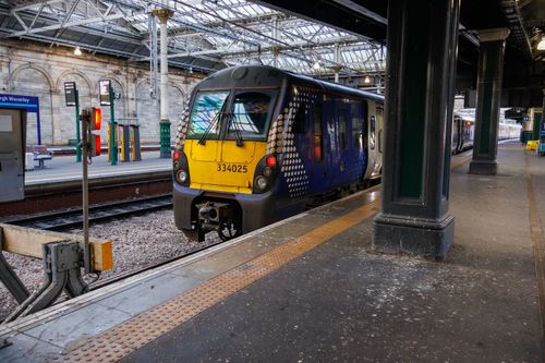 Free A modern train parked at Edinburgh Waverley Station platform, Scotland. Stock Photo