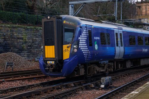 Free A modern ScotRail train captured at a station in Scotland, highlighting its sleek design and vibrant colors. Stock Photo