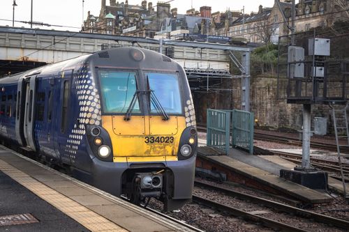 Free A ScotRail train at a platform in Edinburgh, Scotland, showcasing urban transit. Stock Photo