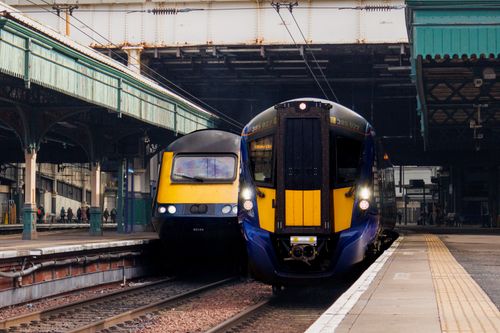 Free Two trains at Edinburgh Waverley Station, showcasing classic Scottish rail architecture. Stock Photo
