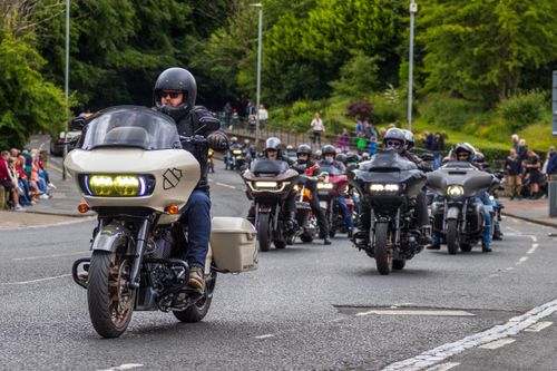 Free A motorcycle parade with riders in Morpeth, England showcasing various bikes and bikers. Stock Photo