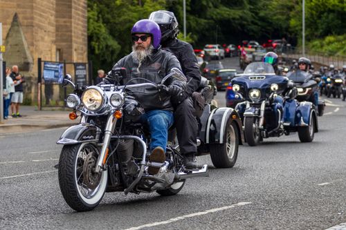 Free Motorcyclists enjoy a ride on classic bikes through the streets of Morpeth, England. Stock Photo