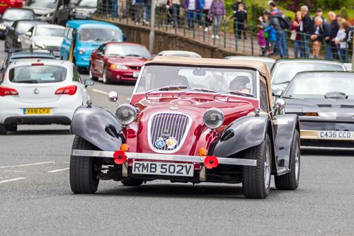 Free Vintage car leading a parade on a busy street in Morpeth, England. Stock Photo