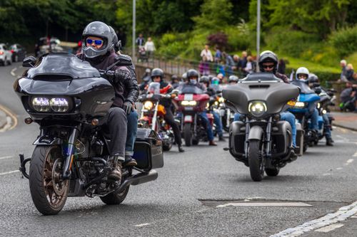 Free Bikers on a group motorcycle ride through the streets of Morpeth, showcasing a diverse range of motorbikes. Stock Photo