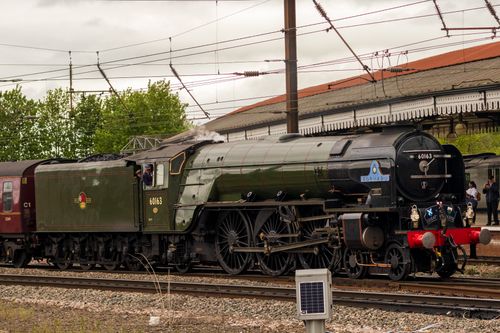 Free A classic steam locomotive 60163 Tornado at a railway station with passengers nearby. Stock Photo