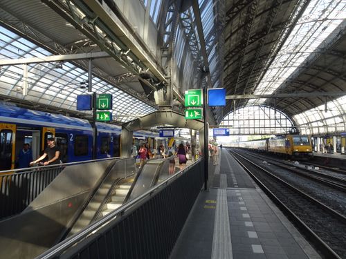 Free Interior view of Rotterdam Central train station showcasing its modern architecture and bustling activity. Stock Photo