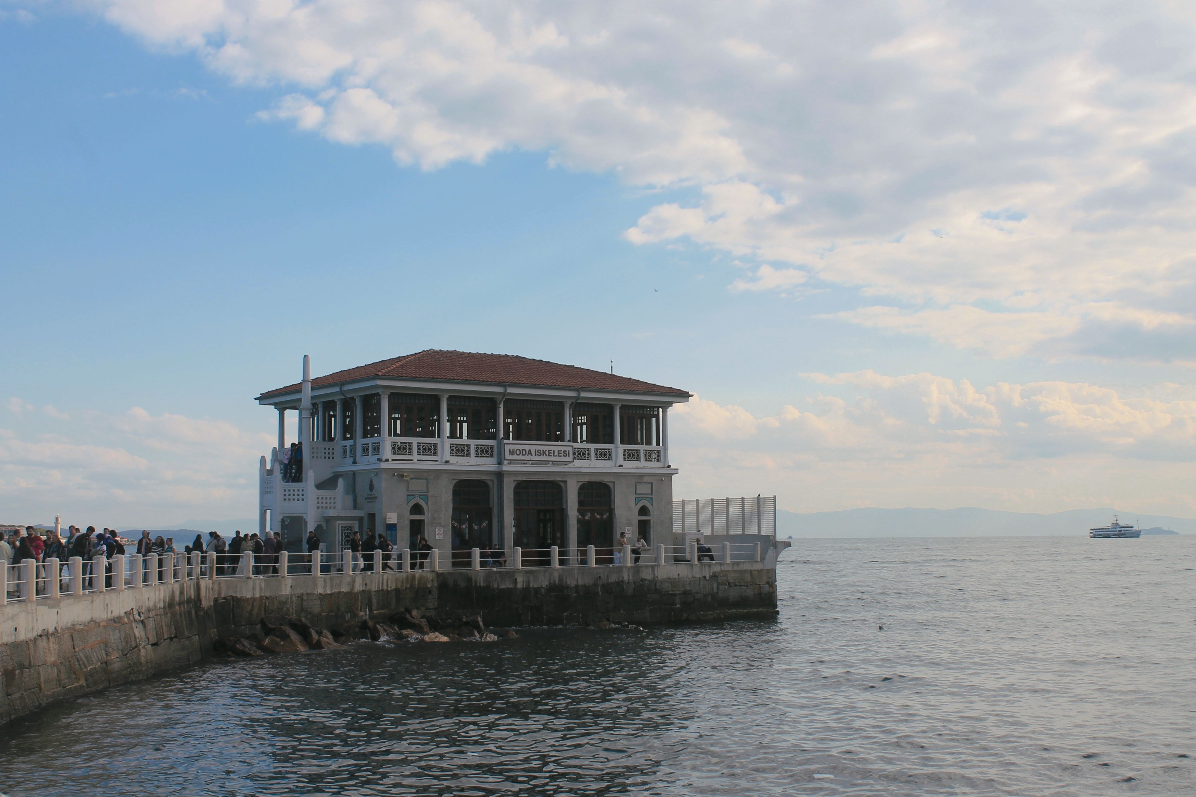 Beautiful day at Moda Iskele in Istanbul with crowds enjoying the waterside view.