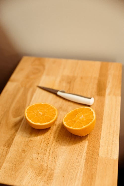 Sliced Orange Fruit On Brown Wooden Chopping Board